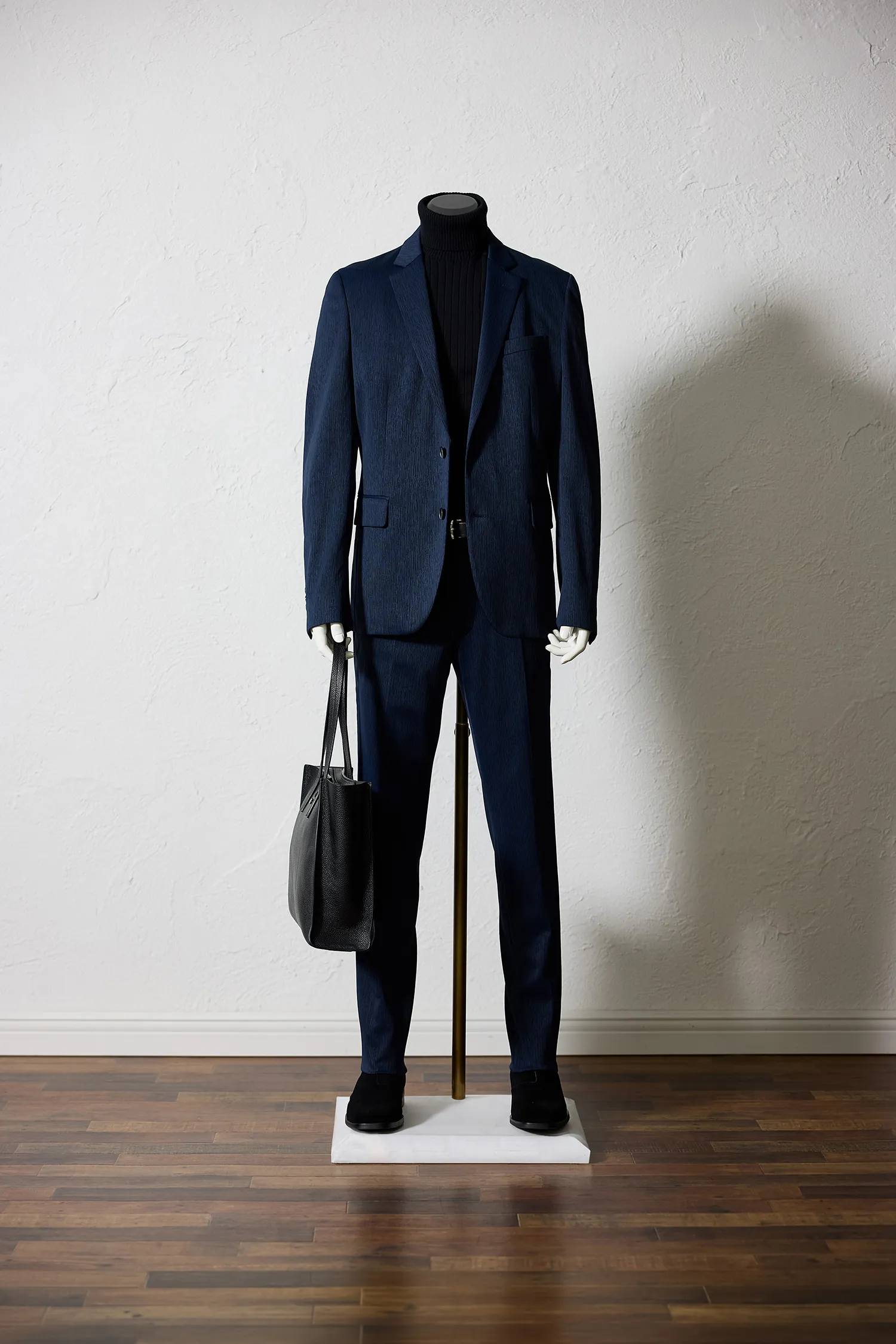 EPOCA UOMOのネイビーのジャージーセットアップにブラックのタートルネックを合わせたコーディネート